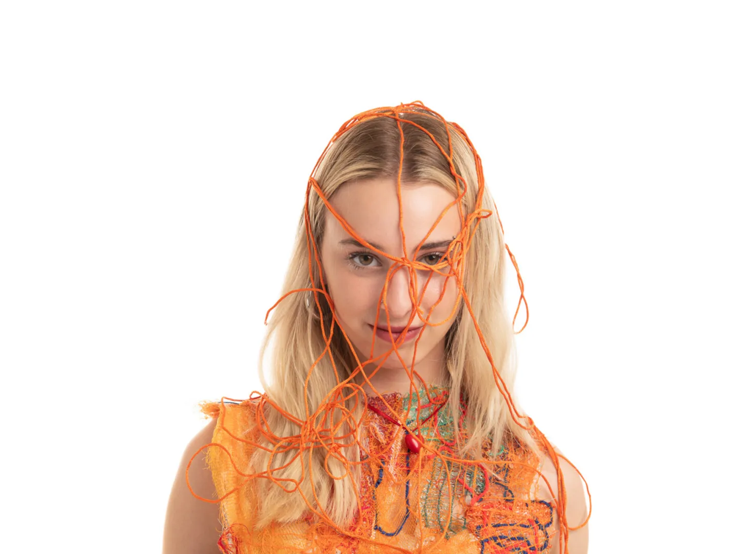 Woman with bright coloured string over her head