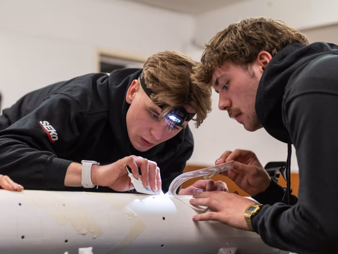 Two students working on rocket decals