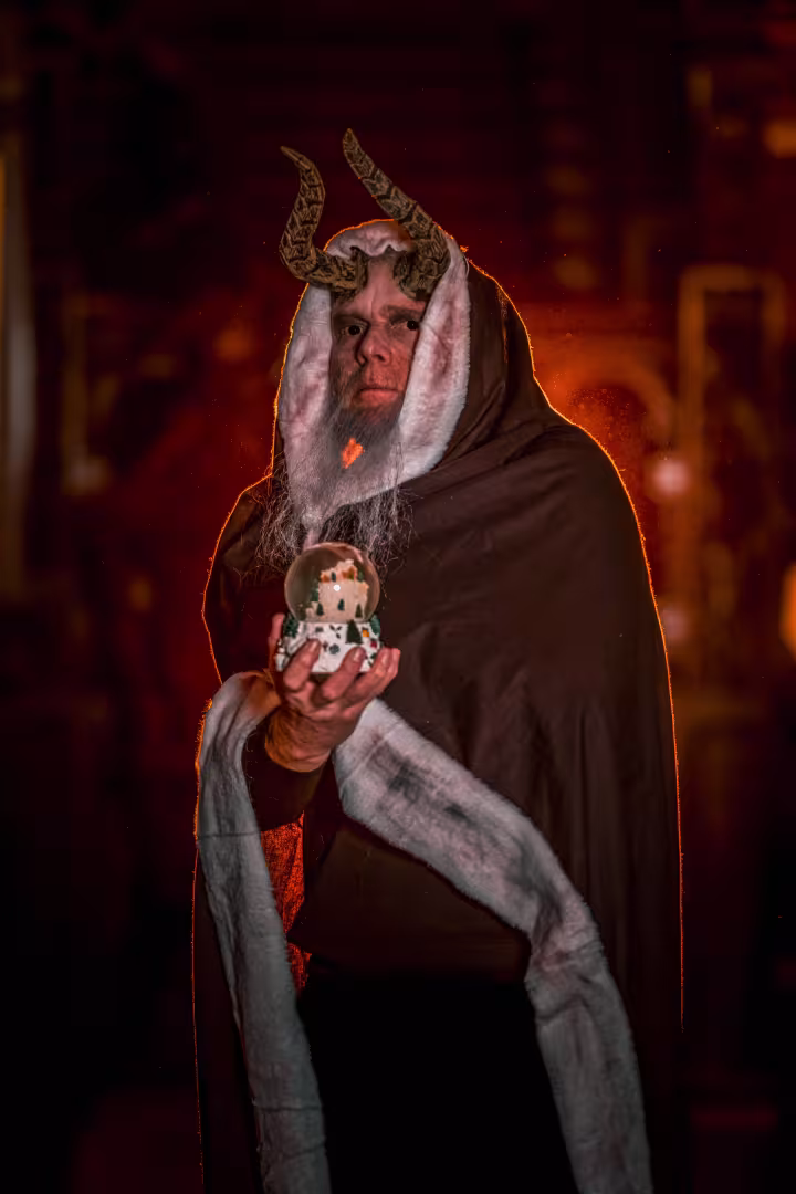 Krampus holding a snow globe
