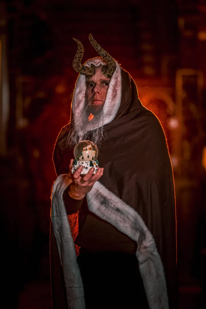Krampus holding a snow globe