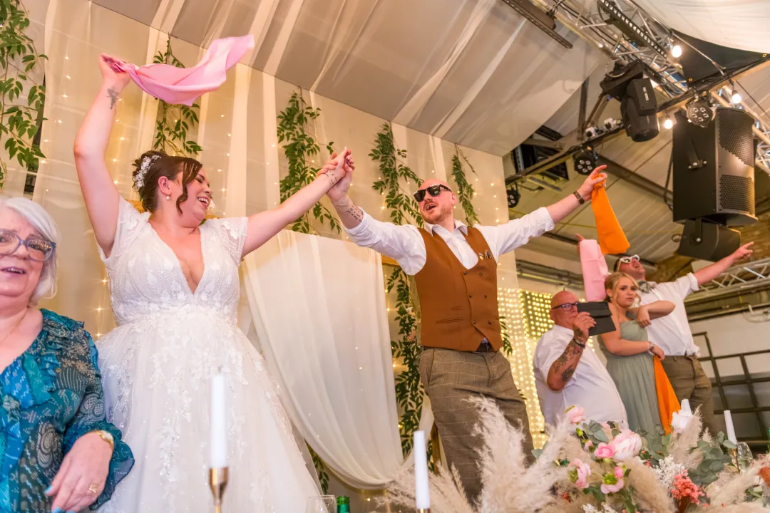 Couple standing on chairs