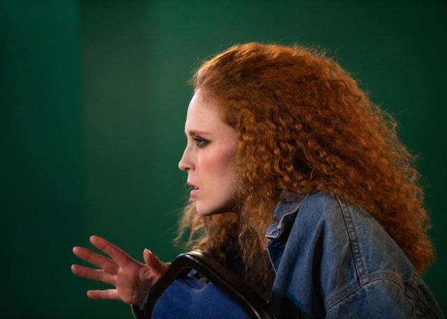 Side profile of a ginger woman with intense look