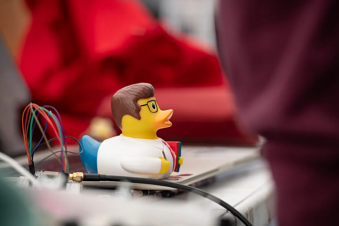 Rubber ducky with shirt and tie hold a notbook and wearing glasses