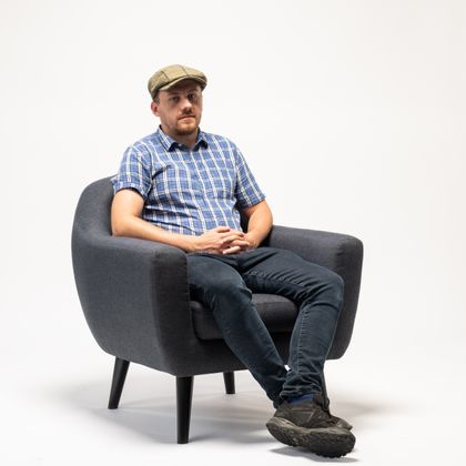 Man sitting in a chair with hat on