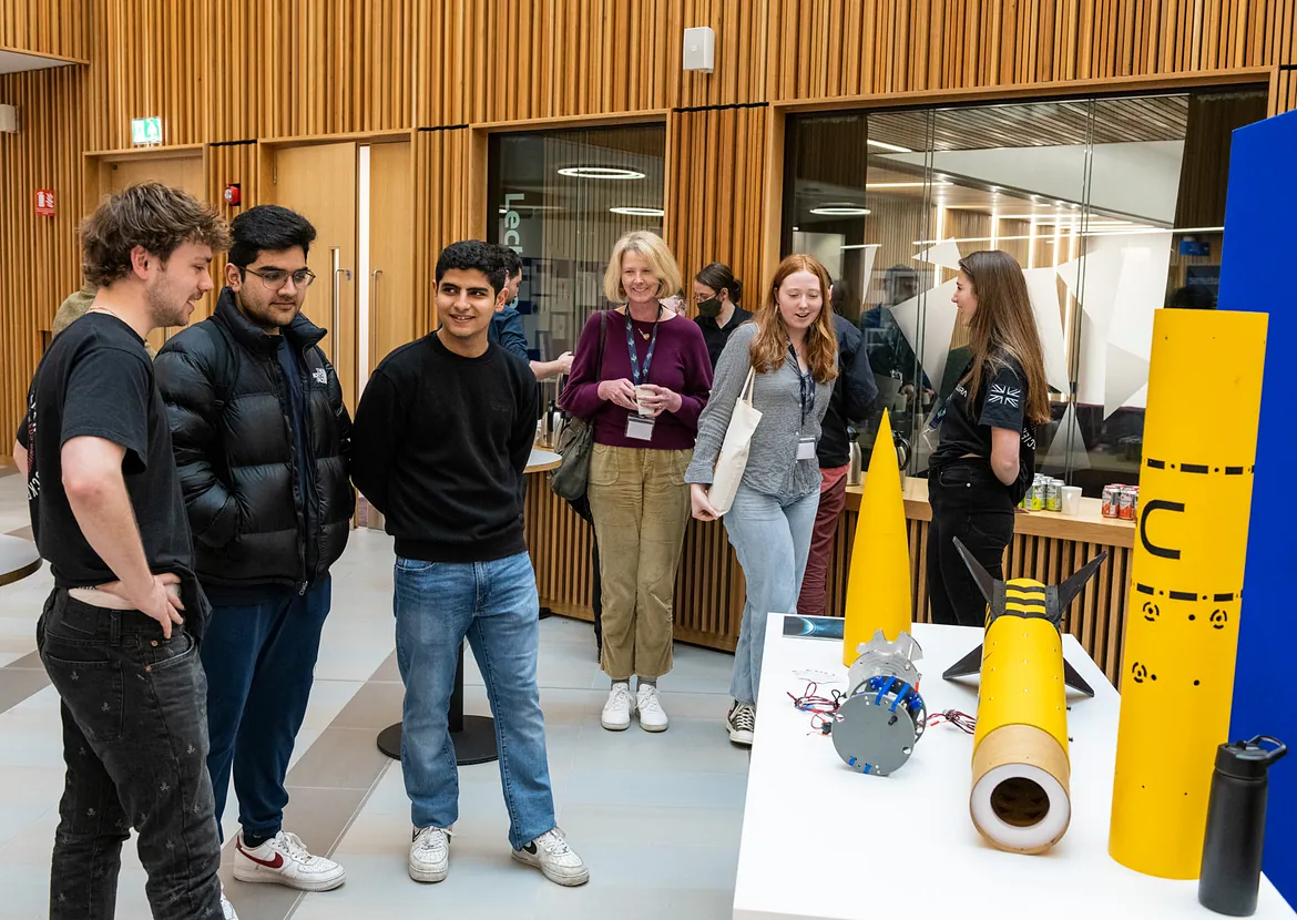 Student exhibition of a rocket, talkting to new students