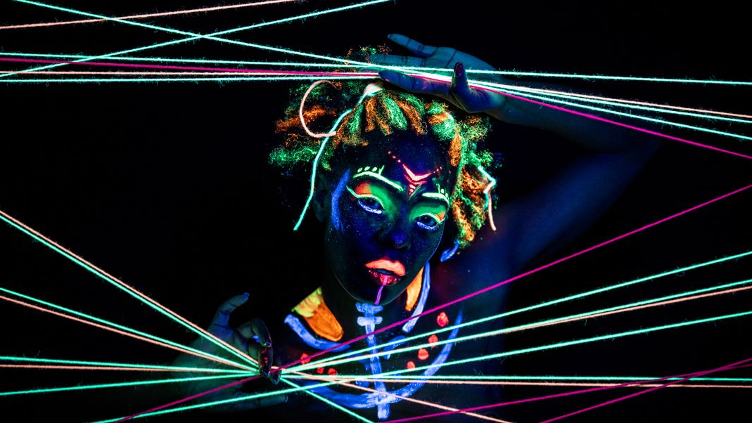 Neon ultraviolet wool with painted woman peering through the wool