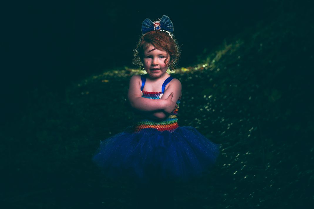 Little girl dressed as chucky arms crossed