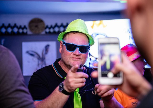 Man with light up glasses and neon green hat