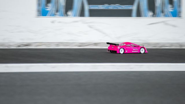 Pink RC car going fast down the straight