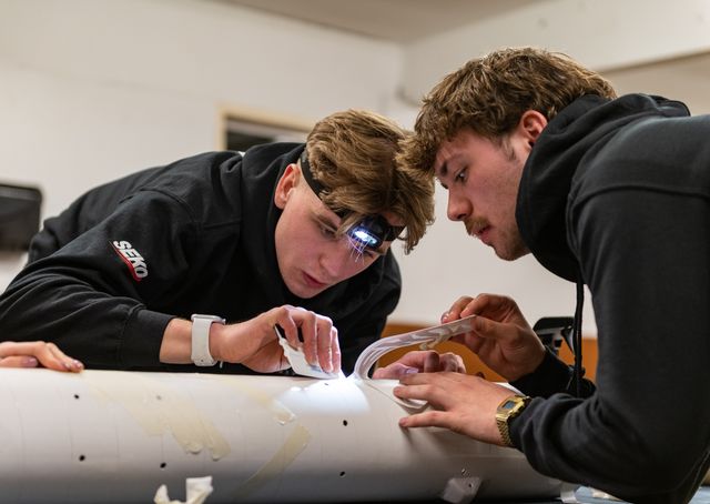 Students adding sponsors to the rocket 